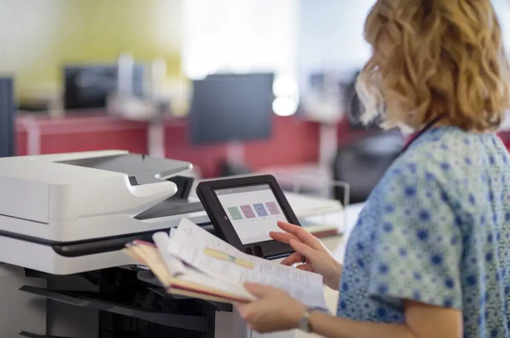 Employee using printer in the workplace