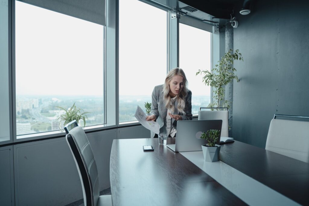 A woman attending a video meeting in the office 