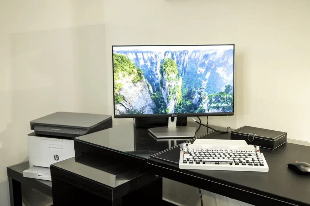 An HP printer set up next to a computer