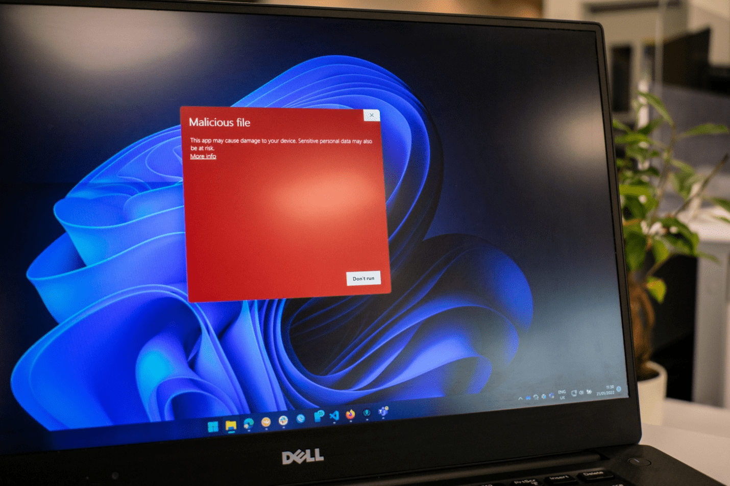 A laptop screen showing a malicious file detected