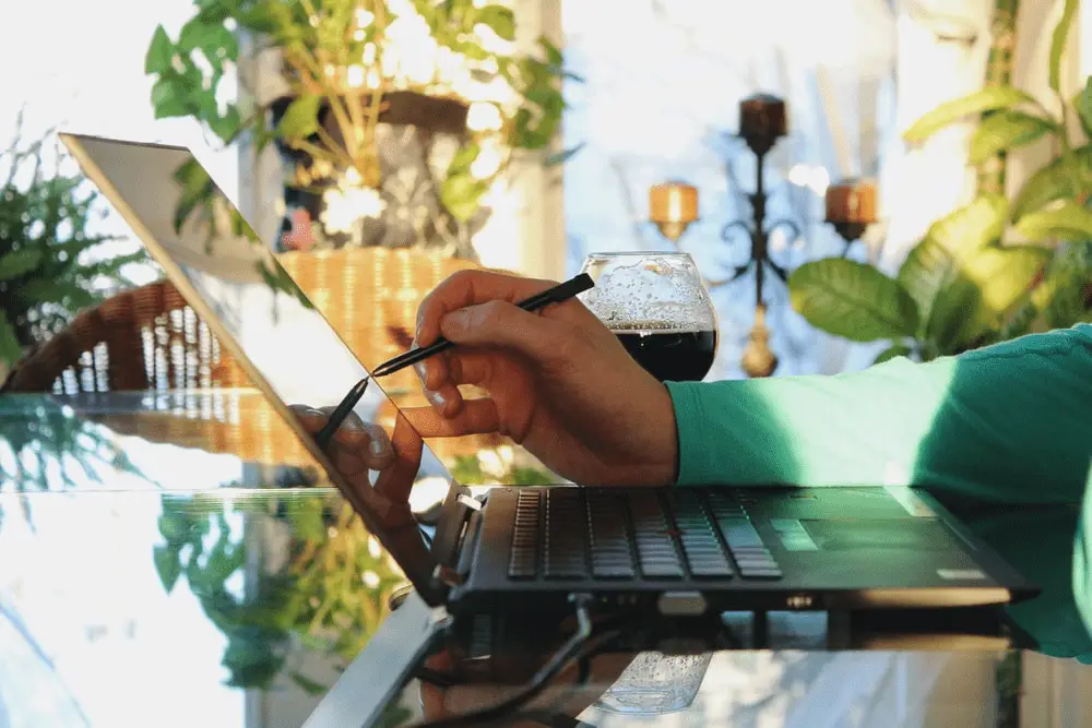 A person using a touch screen laptop