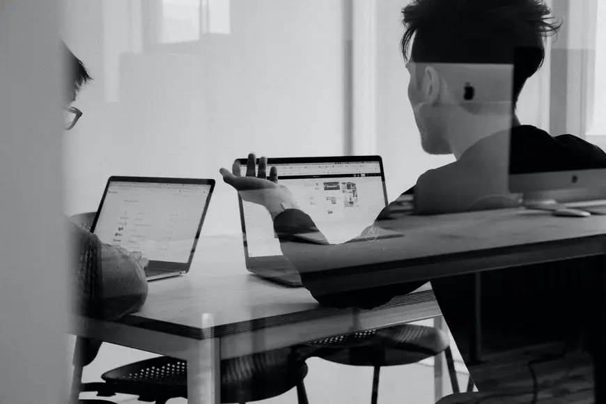 A person using laptop to review printers.