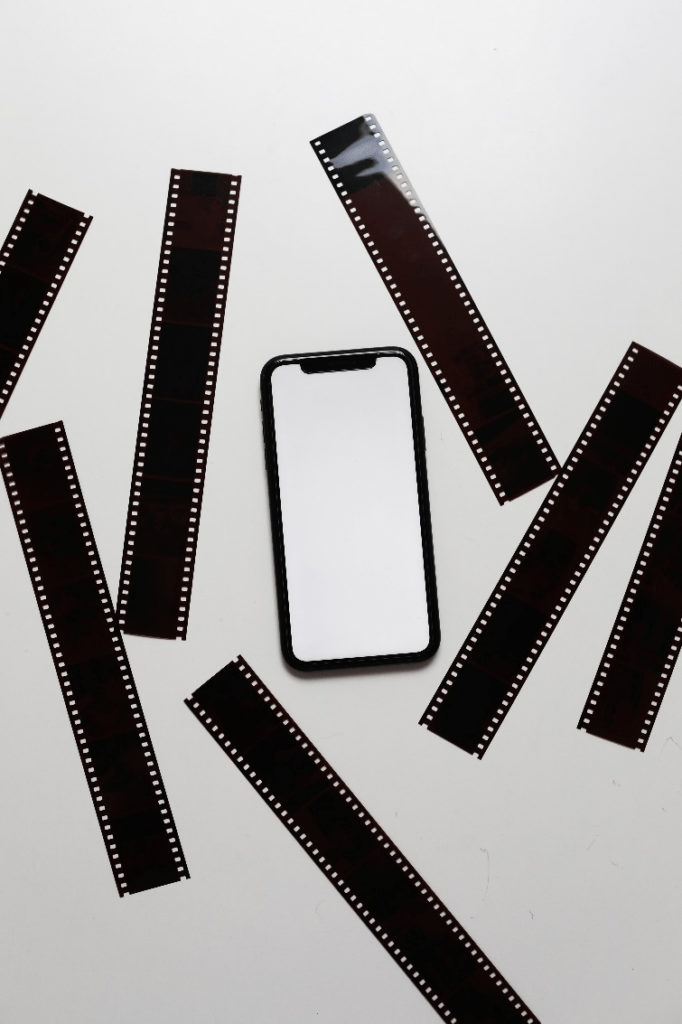 An image of film tapes and a smartphone