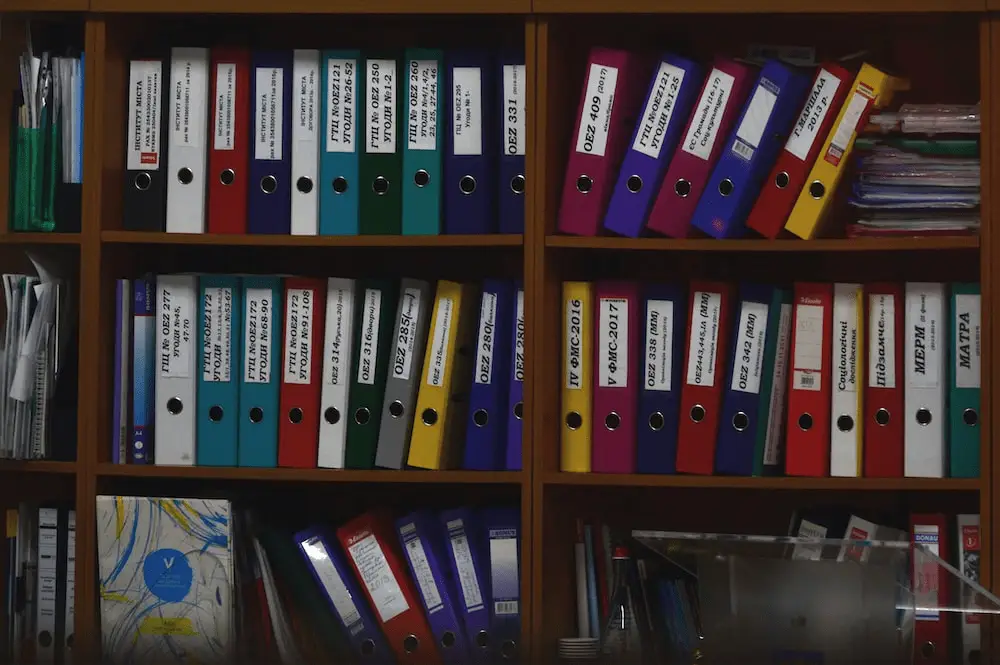 A cabinet with folders in an office.