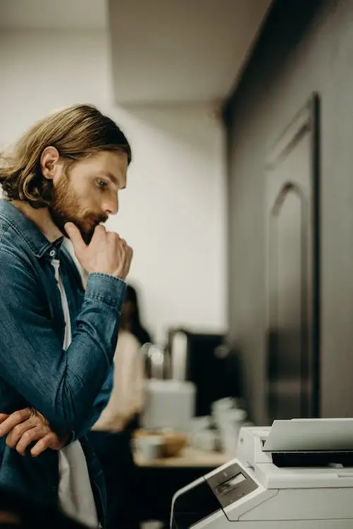 A person looking at printer models.