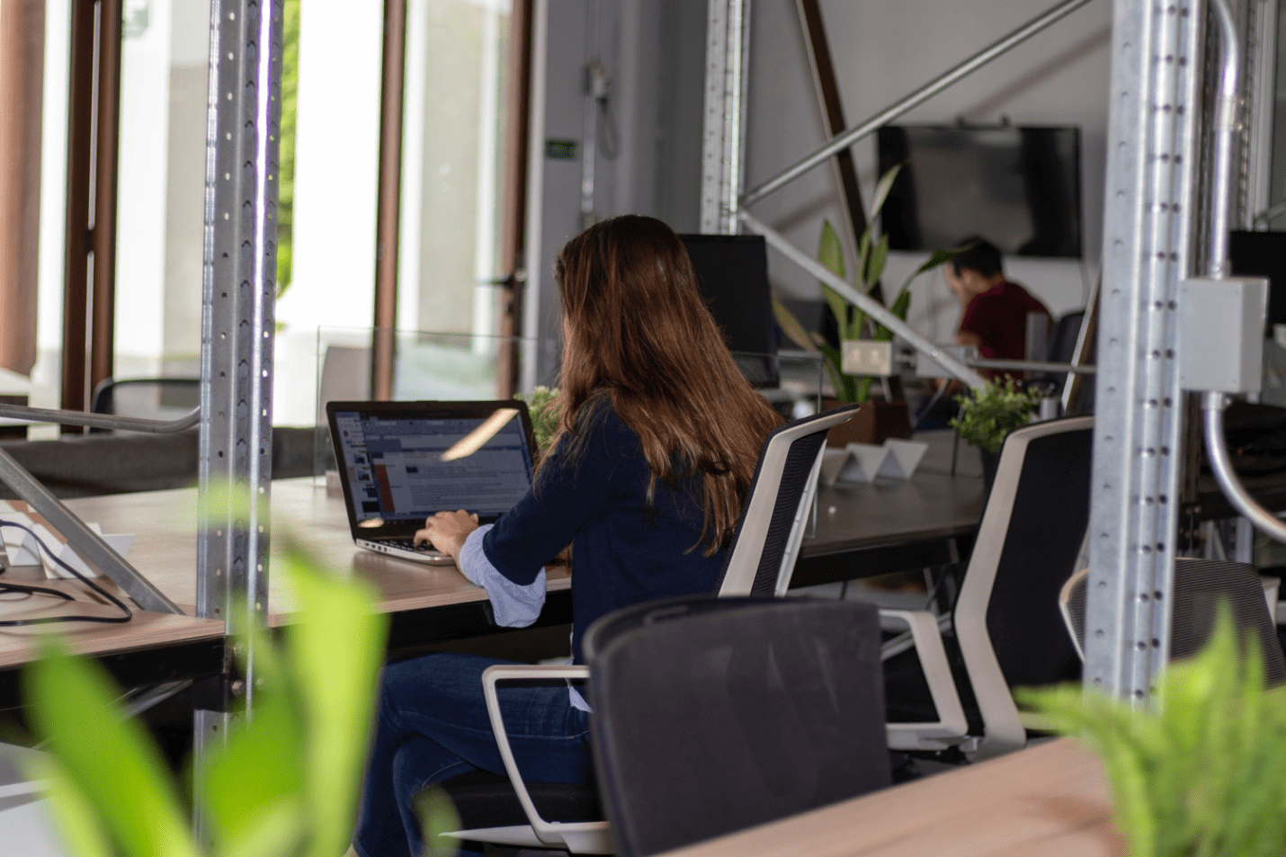 Woman in black long sleeve shirt using a laptop