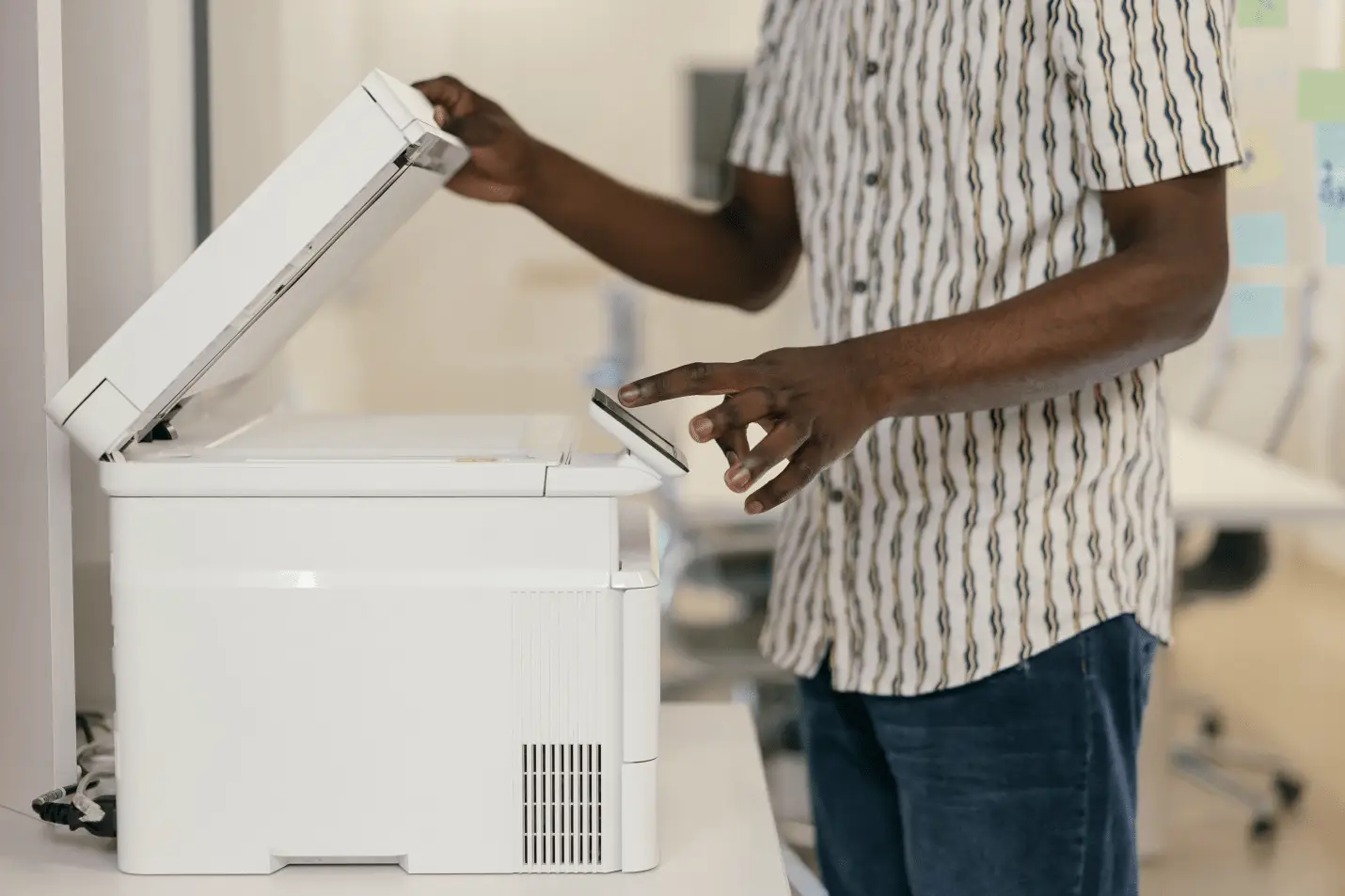 A man using copier in office